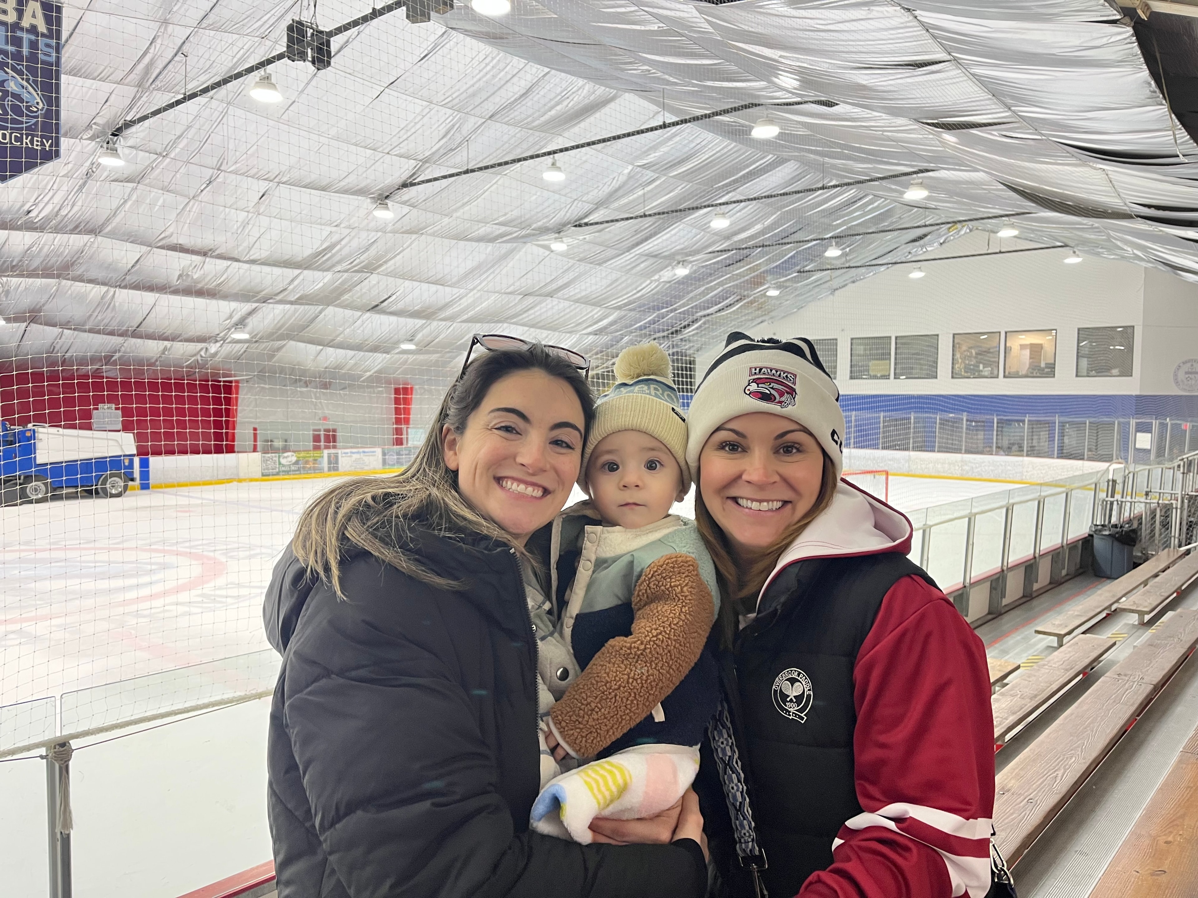 Mothers cheering at a youth hockey game
